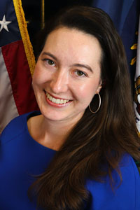 Portrait of Haley Bradburn in front of the American and Kentucky flags.